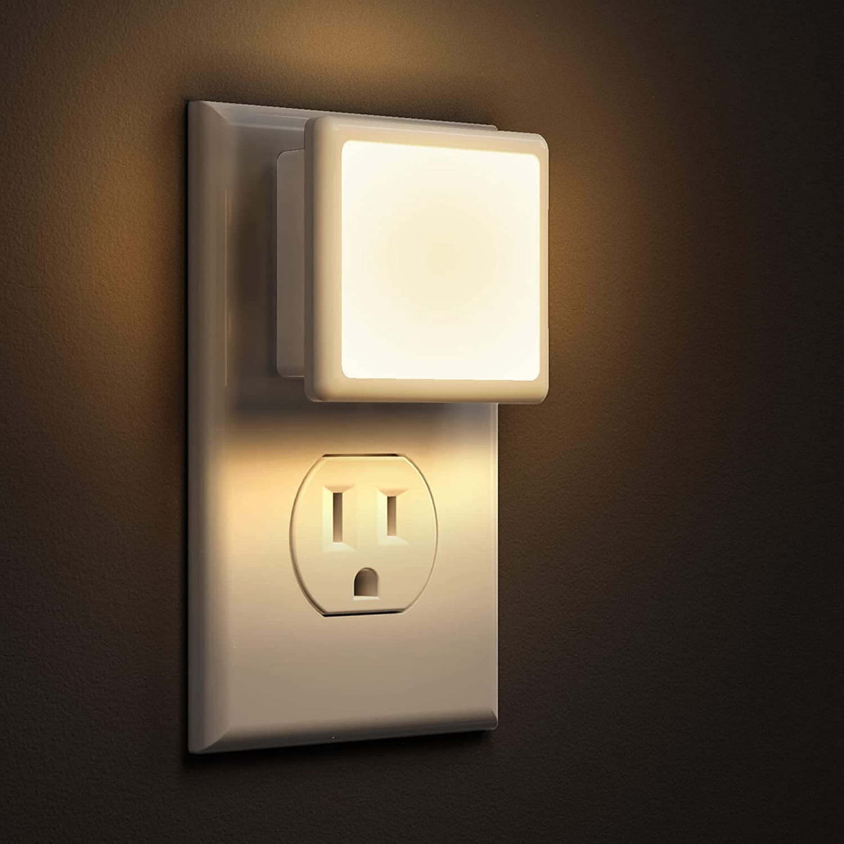 Plug-In Night Light | Dusk to Dawn Auto Sensor LED illuminating a dark wall outlet.